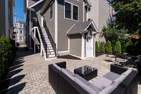 a view of backyard of house with outdoor seating