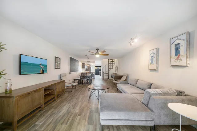 a living room with fireplace furniture and a wooden floor