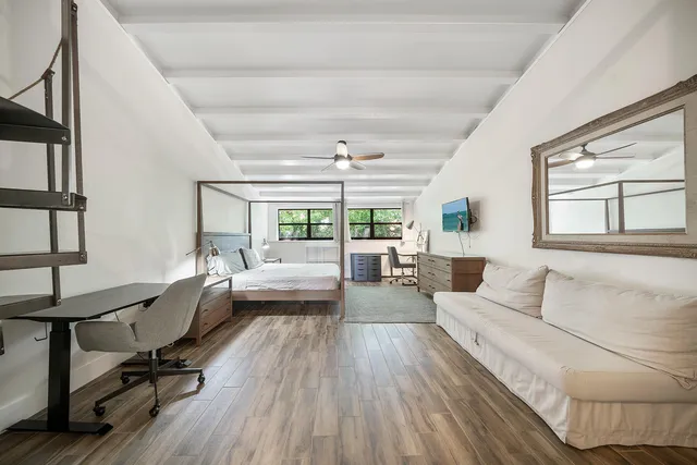 a living room with furniture and a wooden floor