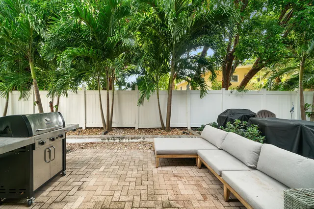 a backyard of a house with table and chairs