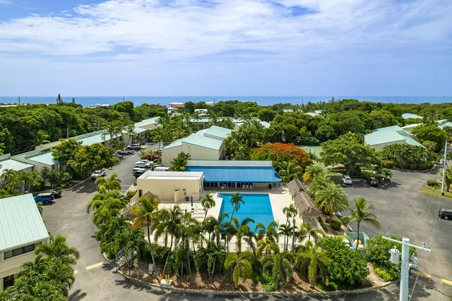 a couple of cars parked in front of a house