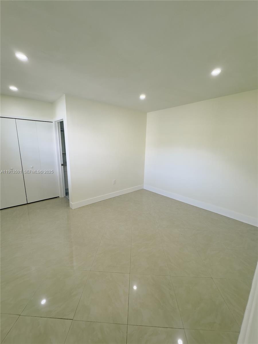 467 Southeast 3rd Street, Unit 1 Hialeah, FL 33010 - Photo 16 of 17 an empty room with a natural light
