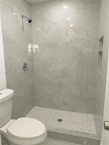 a white toilet and shower