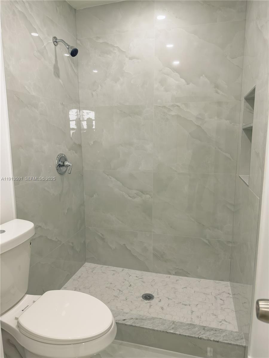 467 Southeast 3rd Street, Unit 1 Hialeah, FL 33010 - Photo 17 of 17 a white toilet and shower