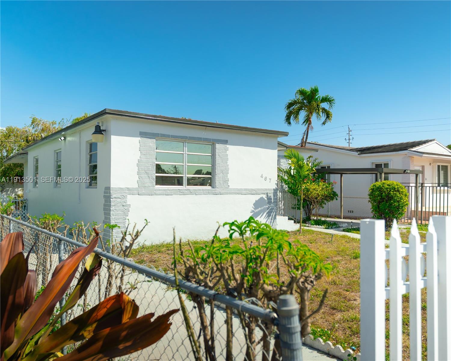 467 Southeast 3rd Street, Unit 1 Hialeah, FL 33010 - Photo 3 of 17 a front view of a house with a yard