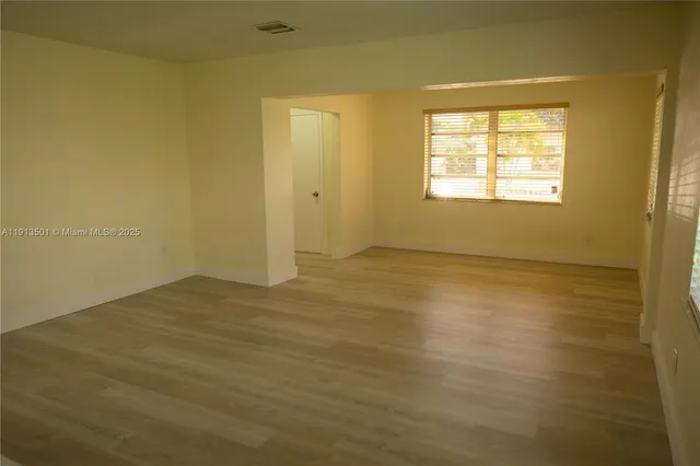 a view of an empty room with a window