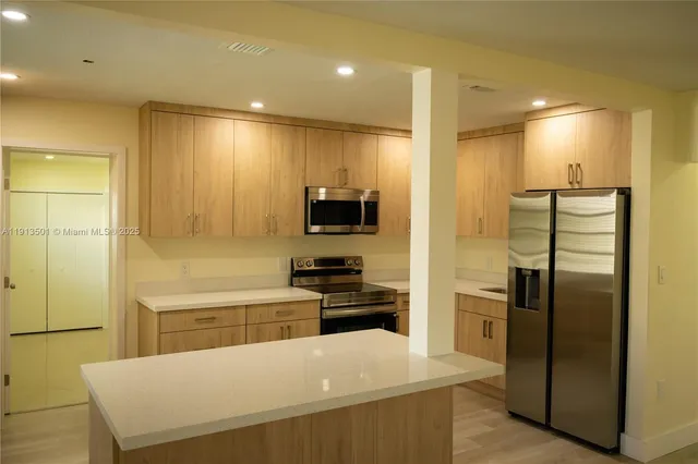 a kitchen with stainless steel appliances a refrigerator and a stove