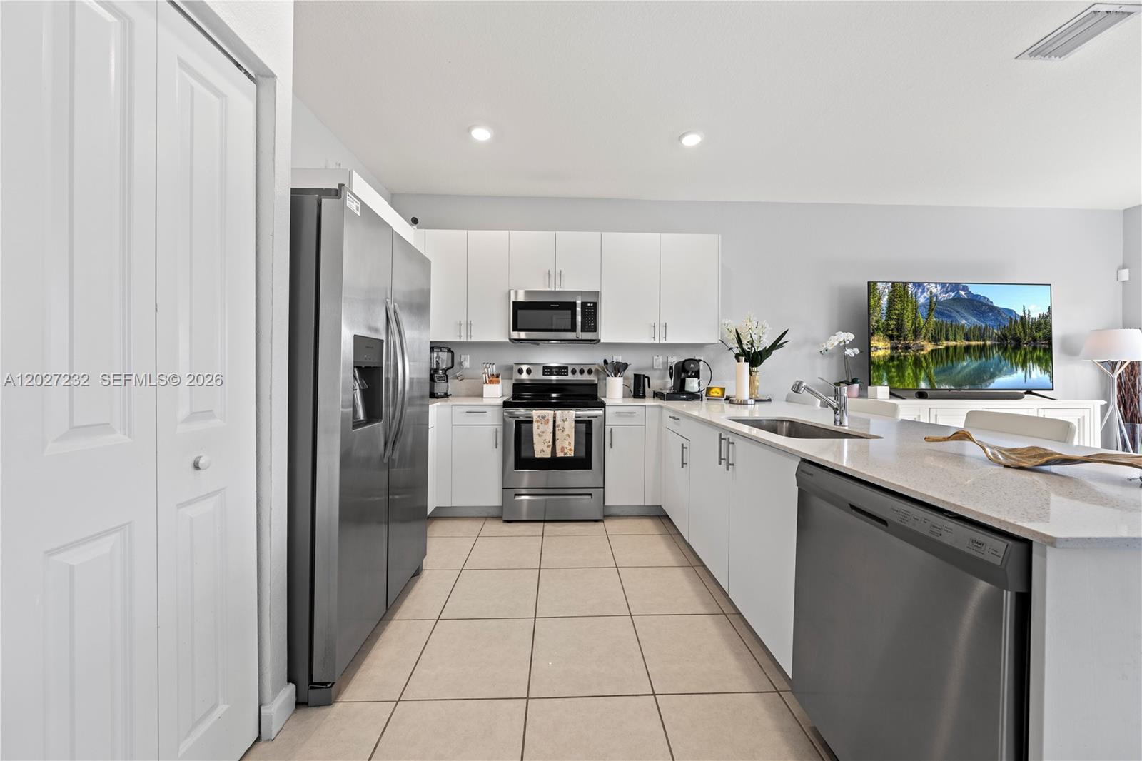 23489 Southwest 127th Place Homestead, FL 33032 - Photo 7 of 24 a kitchen with stainless steel appliances granite countertop a refrigerator and a sink