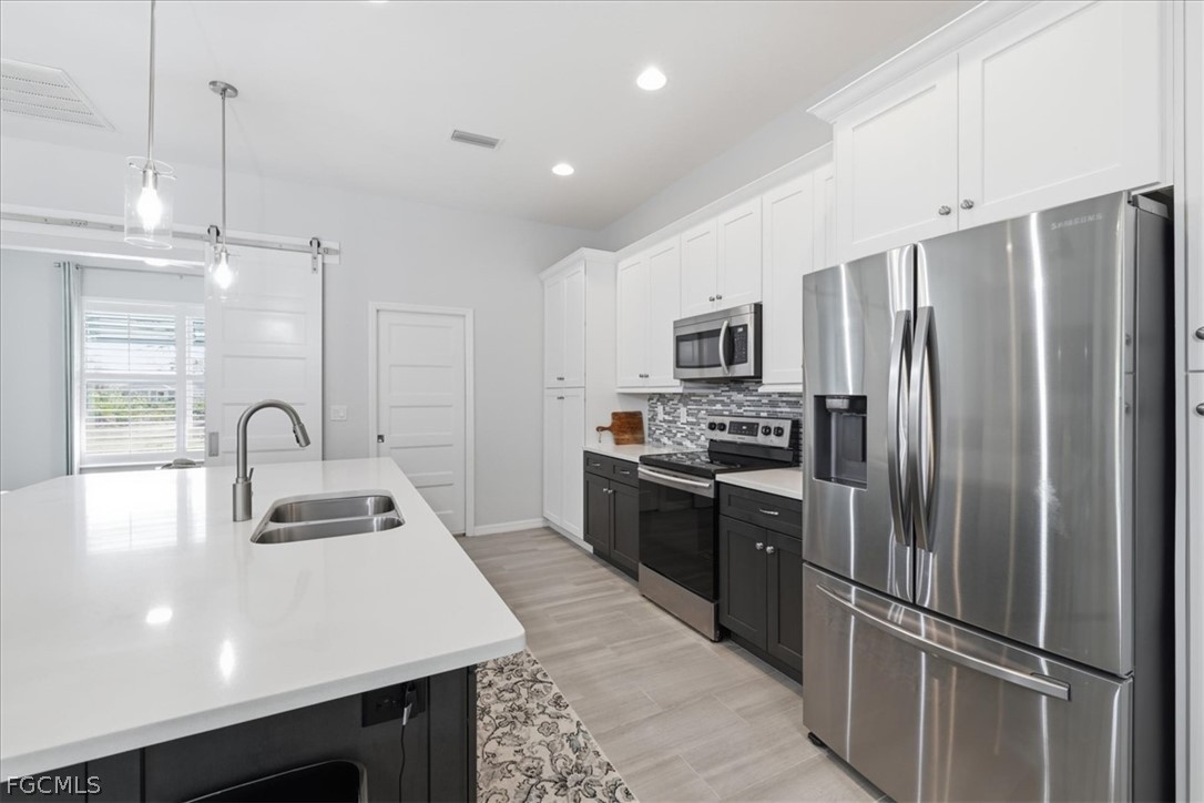 12 Idle Court Placida, FL 33946 - Photo 11 of 41 a kitchen with stainless steel appliances a refrigerator sink and microwave