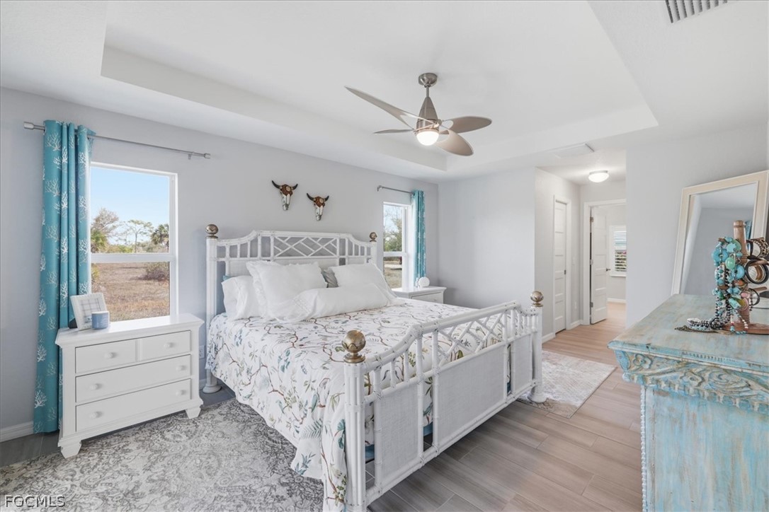12 Idle Court Placida, FL 33946 - Photo 16 of 41 a bedroom with a large bed and a chandelier