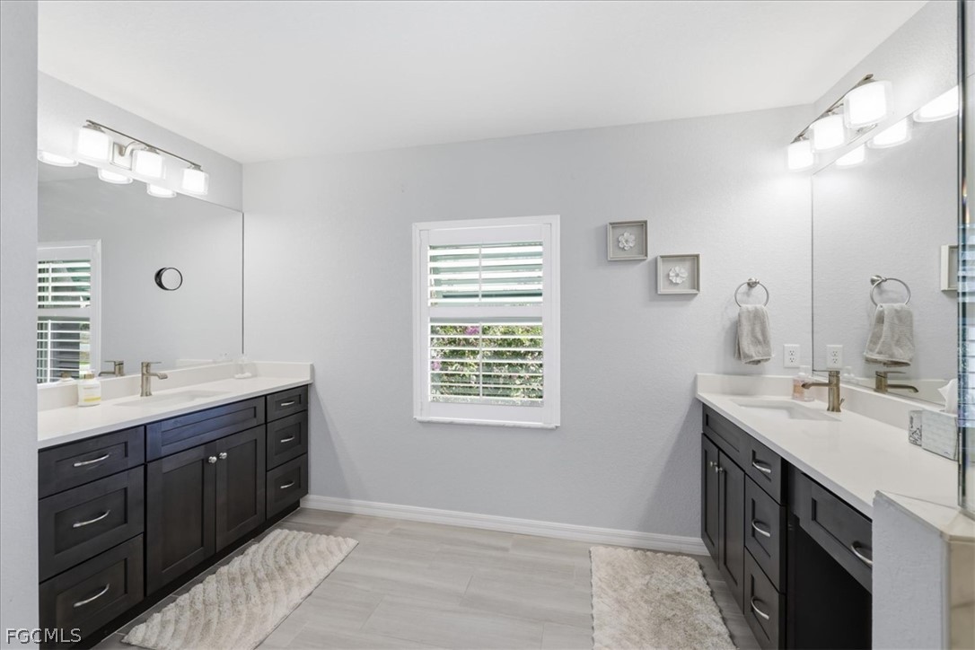 12 Idle Court Placida, FL 33946 - Photo 19 of 41 a spacious bathroom with a double vanity sink mirror and