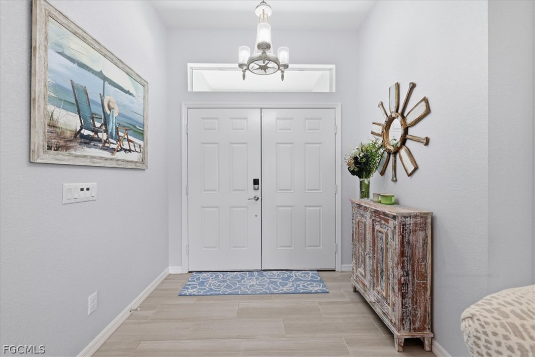 12 Idle Court Placida, FL 33946 - Photo 2 of 41 a view of a hallway with wooden floor and a chandelier
