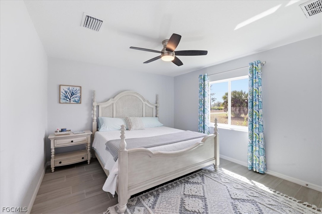 12 Idle Court Placida, FL 33946 - Photo 22 of 41 a bedroom with a bed and a chandelier