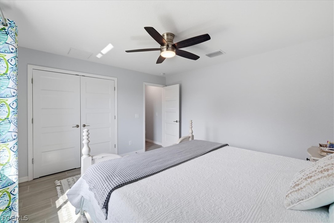 12 Idle Court Placida, FL 33946 - Photo 23 of 41 a bedroom with a large bed and a ceiling fan