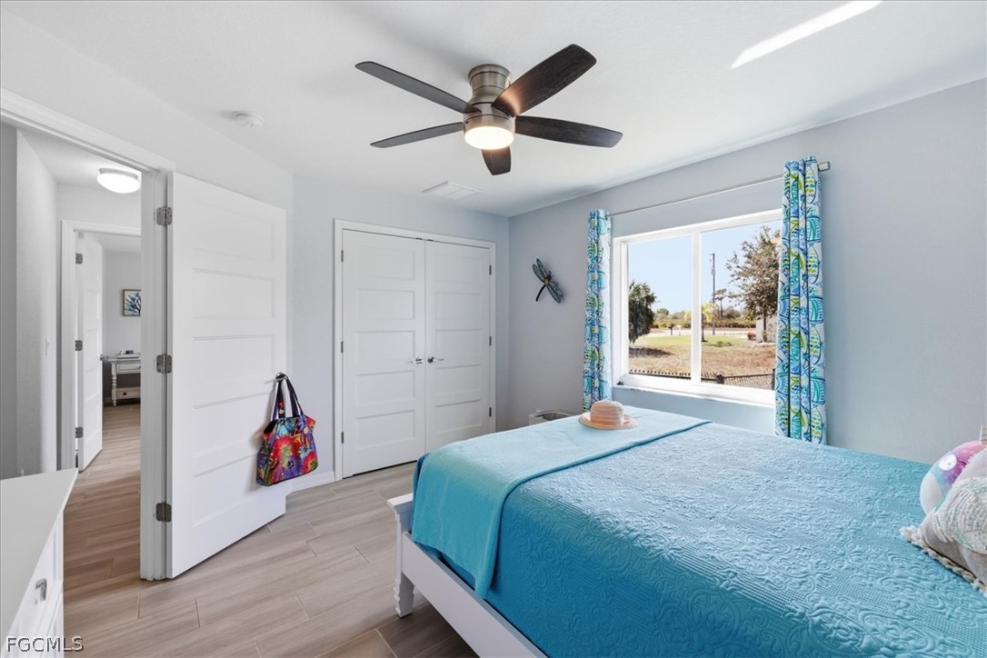 12 Idle Court Placida, FL 33946 - Photo 25 of 41 a bedroom with a large bed and a chandelier