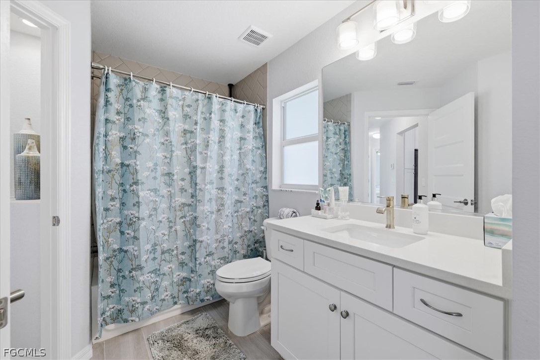 12 Idle Court Placida, FL 33946 - Photo 26 of 41 a bathroom with a double vanity sink mirror and toilet