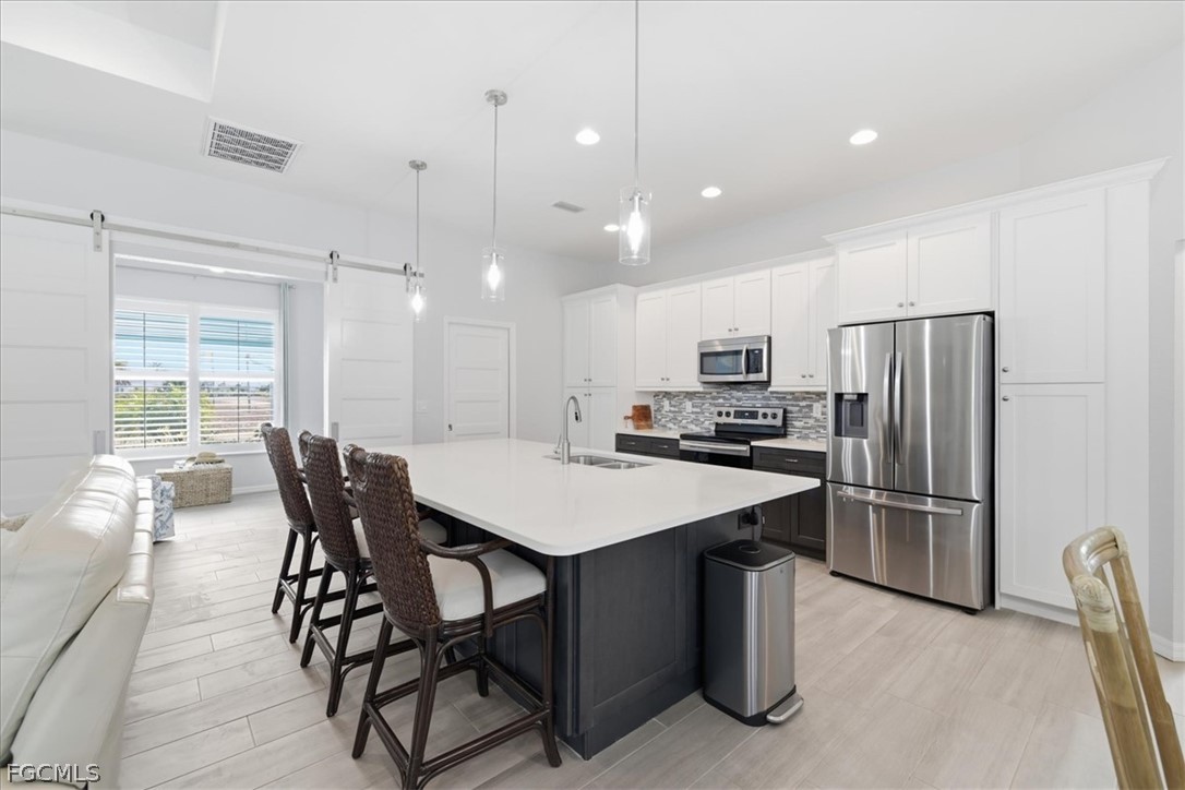 12 Idle Court Placida, FL 33946 - Photo 8 of 41 a kitchen with a table chairs refrigerator and microwave