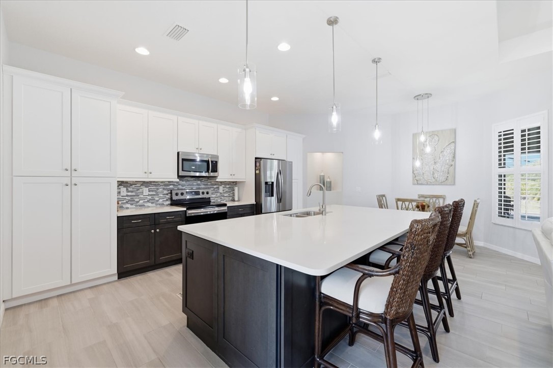 12 Idle Court Placida, FL 33946 - Photo 9 of 41 a kitchen with a table a refrigerator a cabinets and chairs