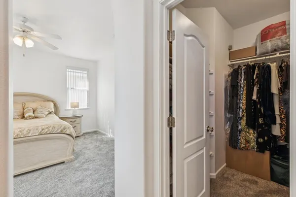 a bedroom with a bed and a walk in closet