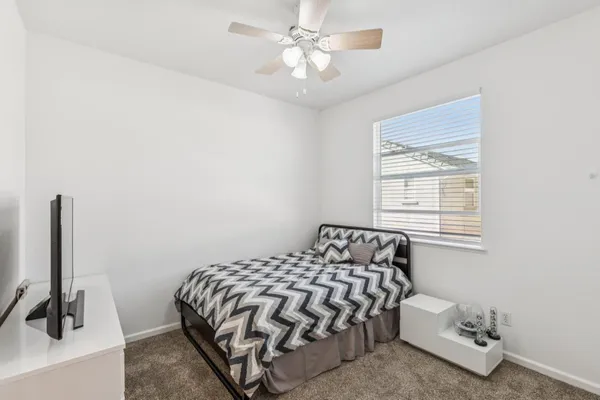 a bedroom with a bed and a window
