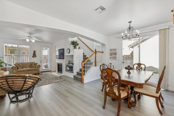 a living room with furniture and a chandelier