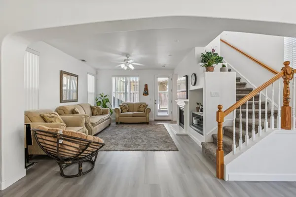 a living room with furniture and a wooden floor