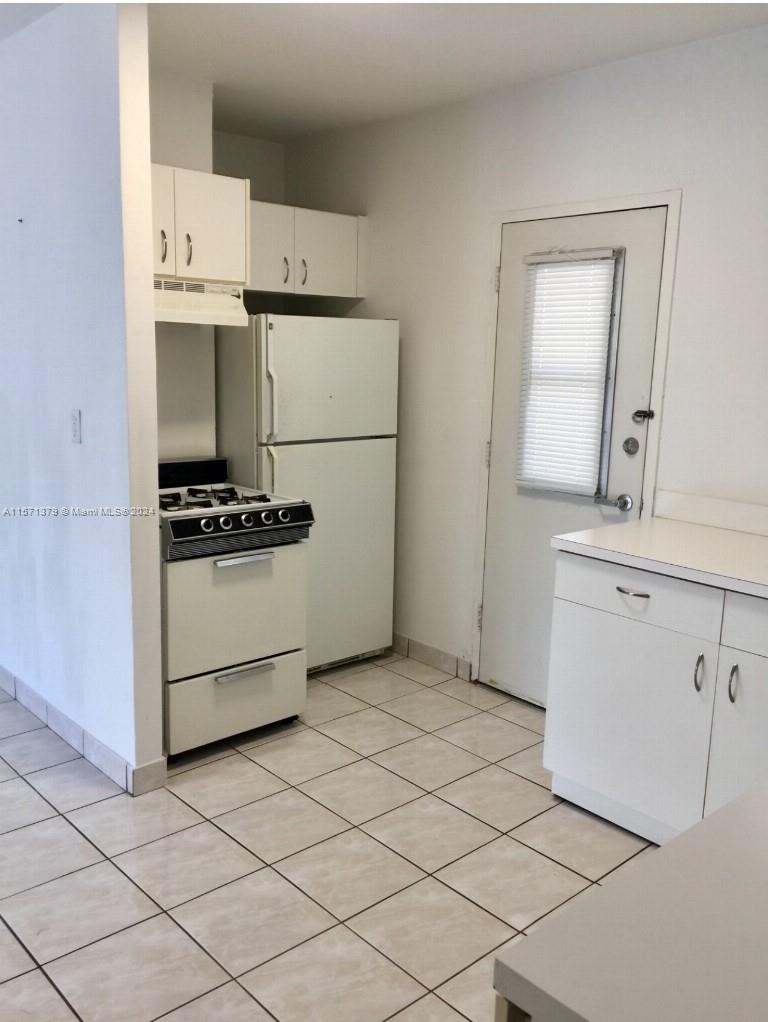 1300 Lincoln Road, Unit B302 Miami Beach, FL 33139 - Photo 4 of 14 a kitchen with cabinets and white appliances