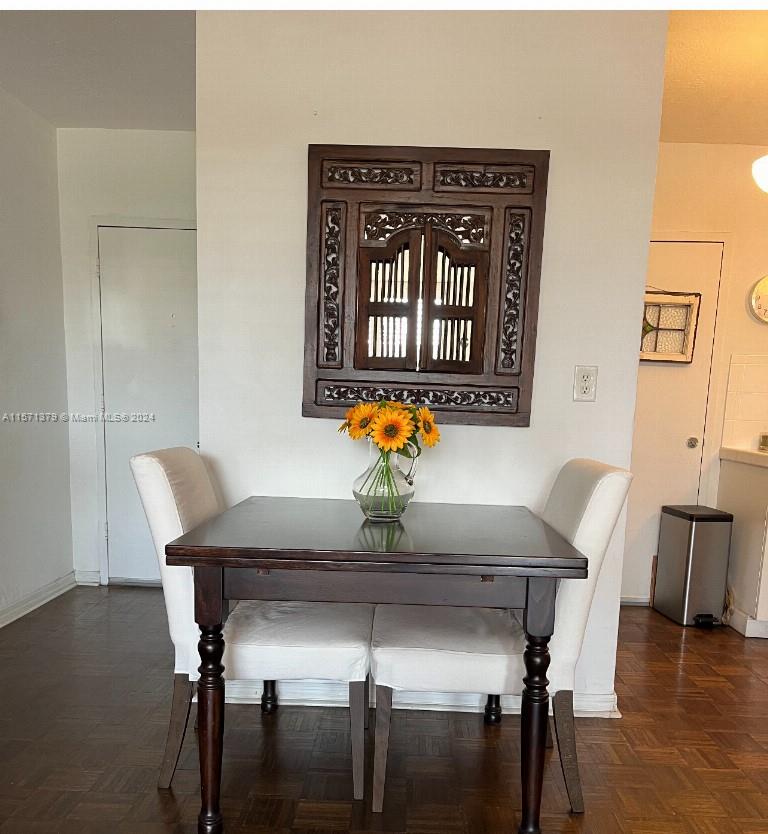 1300 Lincoln Road, Unit B302 Miami Beach, FL 33139 - Photo 6 of 14 a view of a dining room with furniture and wooden floor