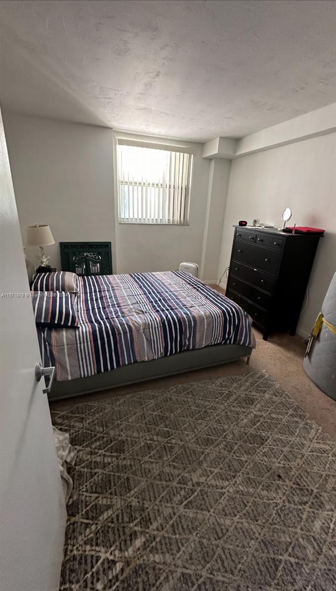 1300 Lincoln Road, Unit B302 Miami Beach, FL 33139 - Photo 7 of 14 a bedroom with a bed and window