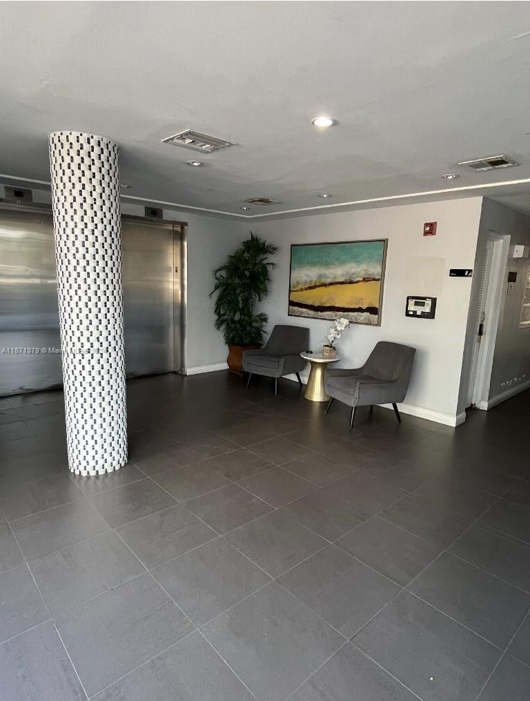1300 Lincoln Road, Unit B302 Miami Beach, FL 33139 - Photo 10 of 14 a living room with furniture and floor to ceiling window