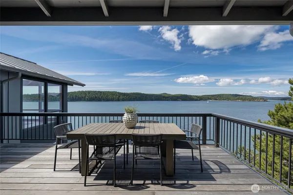 a view of a balcony with furniture and wooden floor