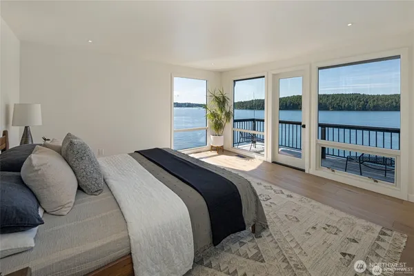 a spacious bedroom with a bed and a large window