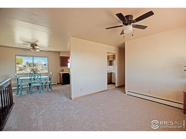 a view of a livingroom with furniture and a ceiling fan