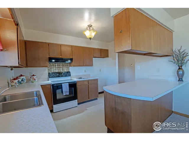 a kitchen with stainless steel appliances a sink a refrigerator and a stove