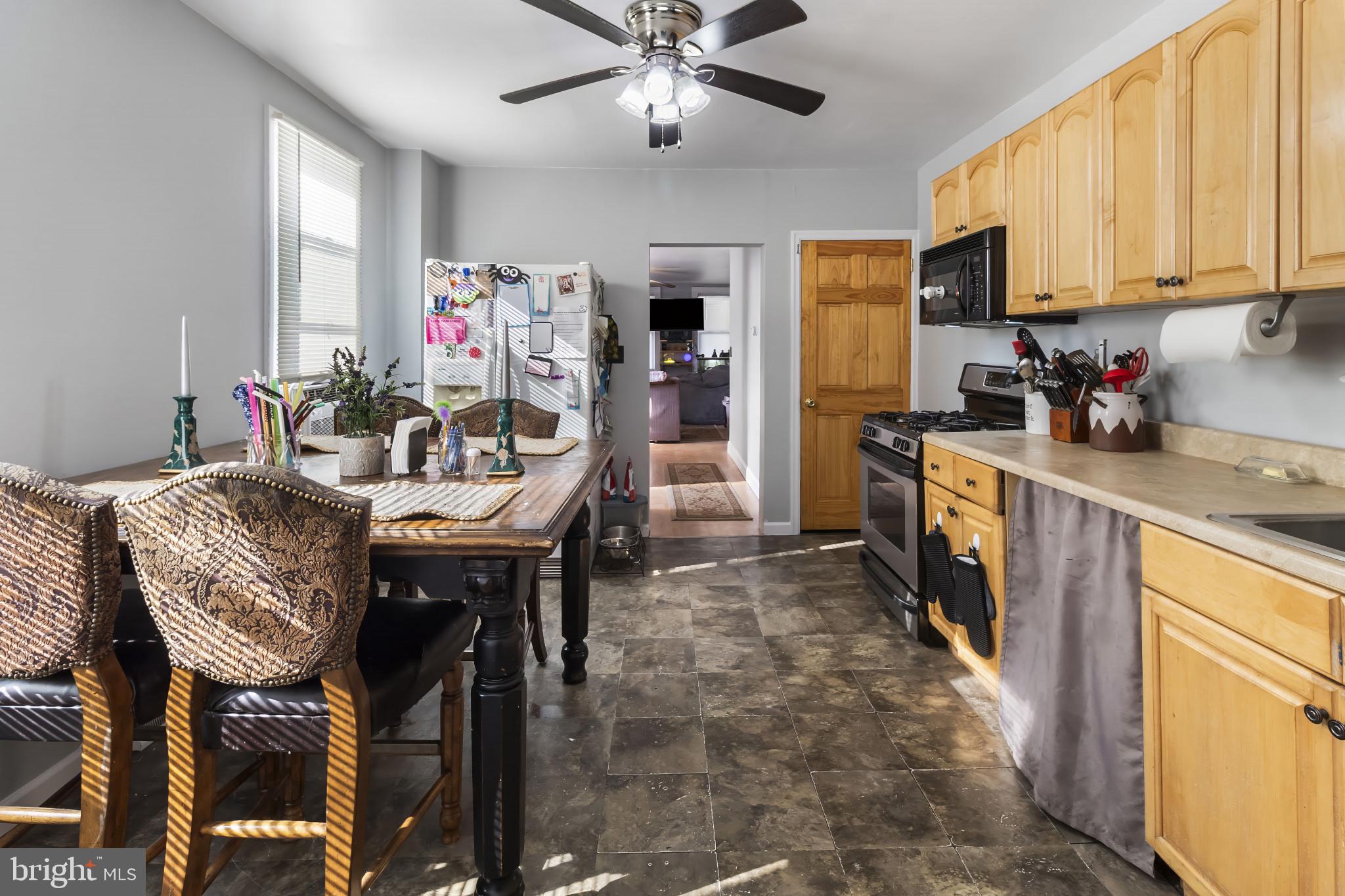 152 1/2 Rancocas Road Mount Holly, NJ 08060 - Photo 12 of 26 a kitchen with granite countertop a dining table chairs stainless steel appliances and cabinets