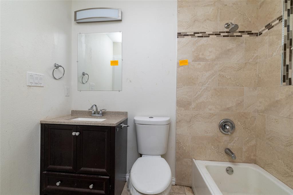 805 East Belt Line Road DeSoto, TX 75115 - Photo 12 of 15 a bathroom with a toilet a sink and mirror