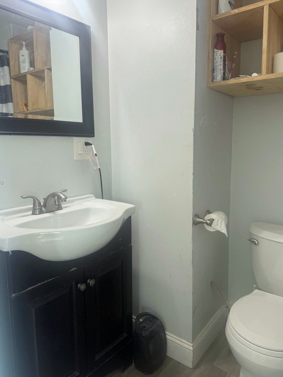 85 Seneca Street Lowell, MA 01852 - Photo 13 of 16 a bathroom with a sink toilet and mirror