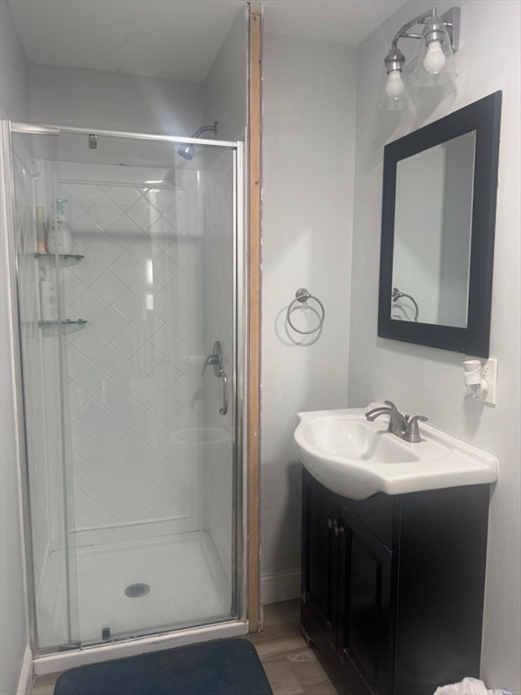 85 Seneca Street Lowell, MA 01852 - Photo 14 of 16 a bathroom with a sink mirror and shower