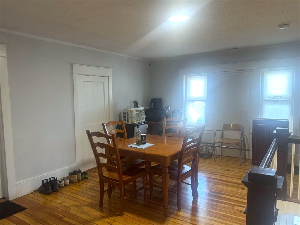 85 Seneca Street Lowell, MA 01852 - Photo 15 of 16 a view of a dining room with furniture and wooden floor