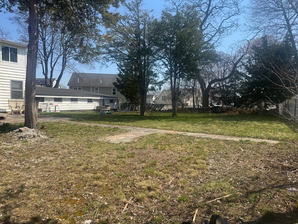 85 Seneca Street Lowell, MA 01852 - Photo 5 of 16 a view of a yard with a fountain