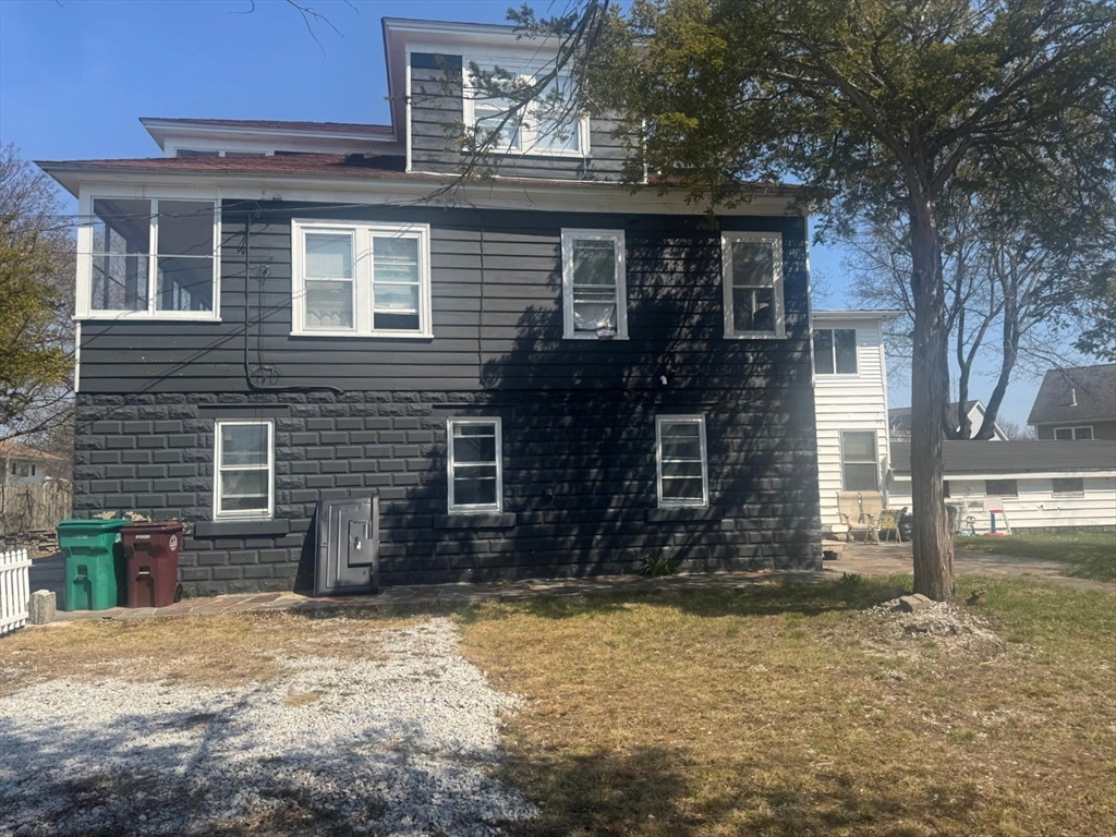 85 Seneca Street Lowell, MA 01852 - Photo 6 of 16 a front view of a house with a yard