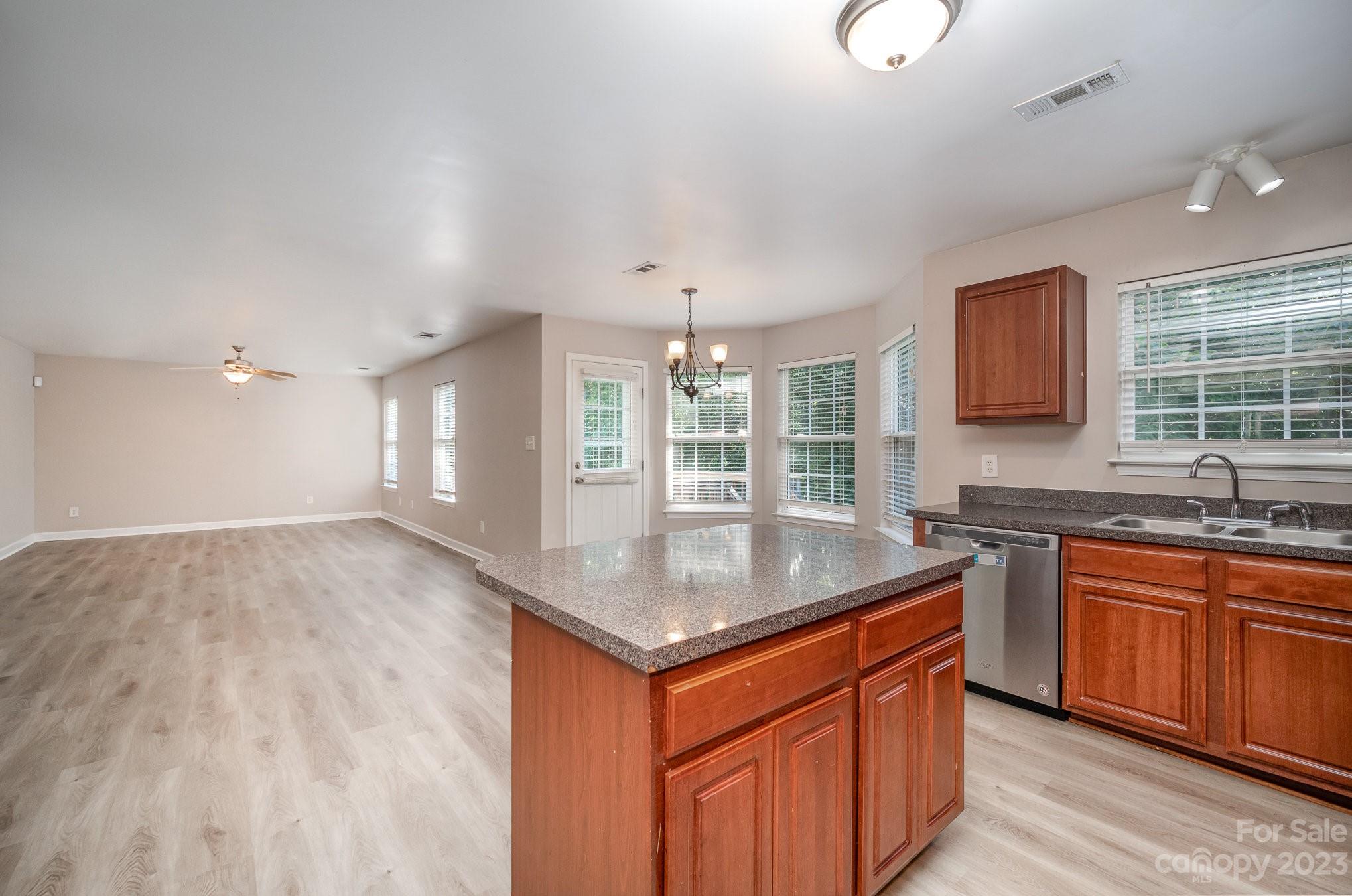 1400 Key Ridge Court Charlotte, NC 28216 - Photo 11 of 27 a kitchen with stainless steel appliances granite countertop a sink stove and cabinets