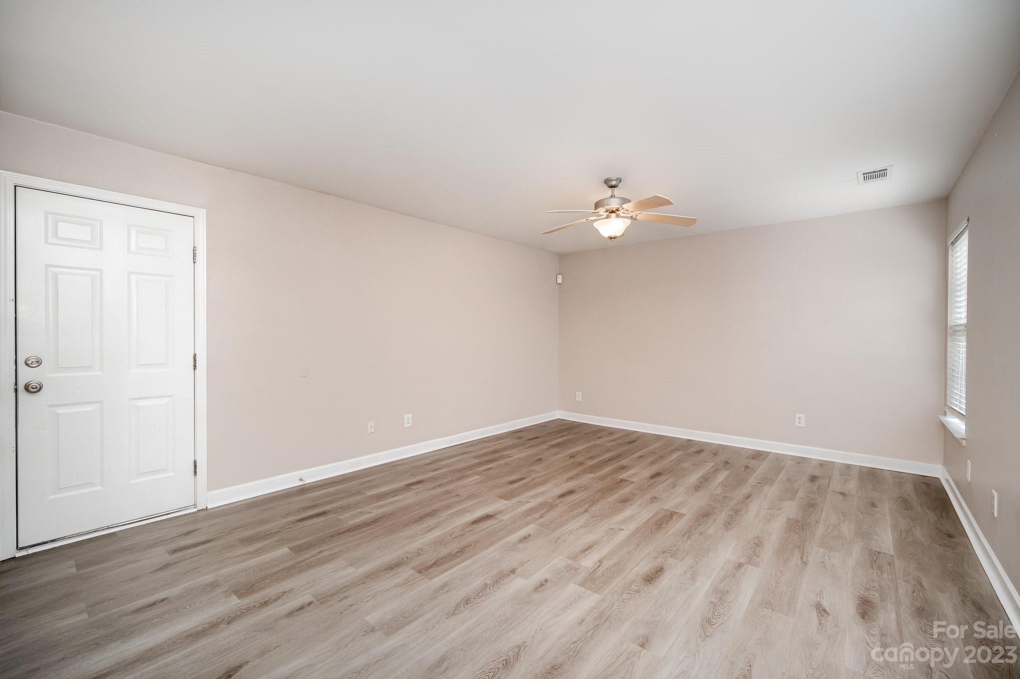 1400 Key Ridge Court Charlotte, NC 28216 - Photo 12 of 27 wooden floor in an empty room with a window