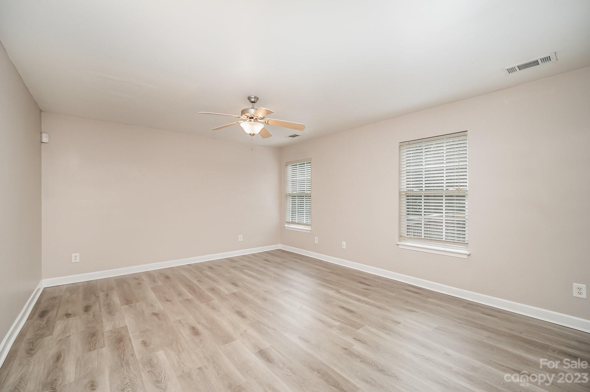 1400 Key Ridge Court Charlotte, NC 28216 - Photo 14 of 27 a view of an empty room with wooden floor and a window