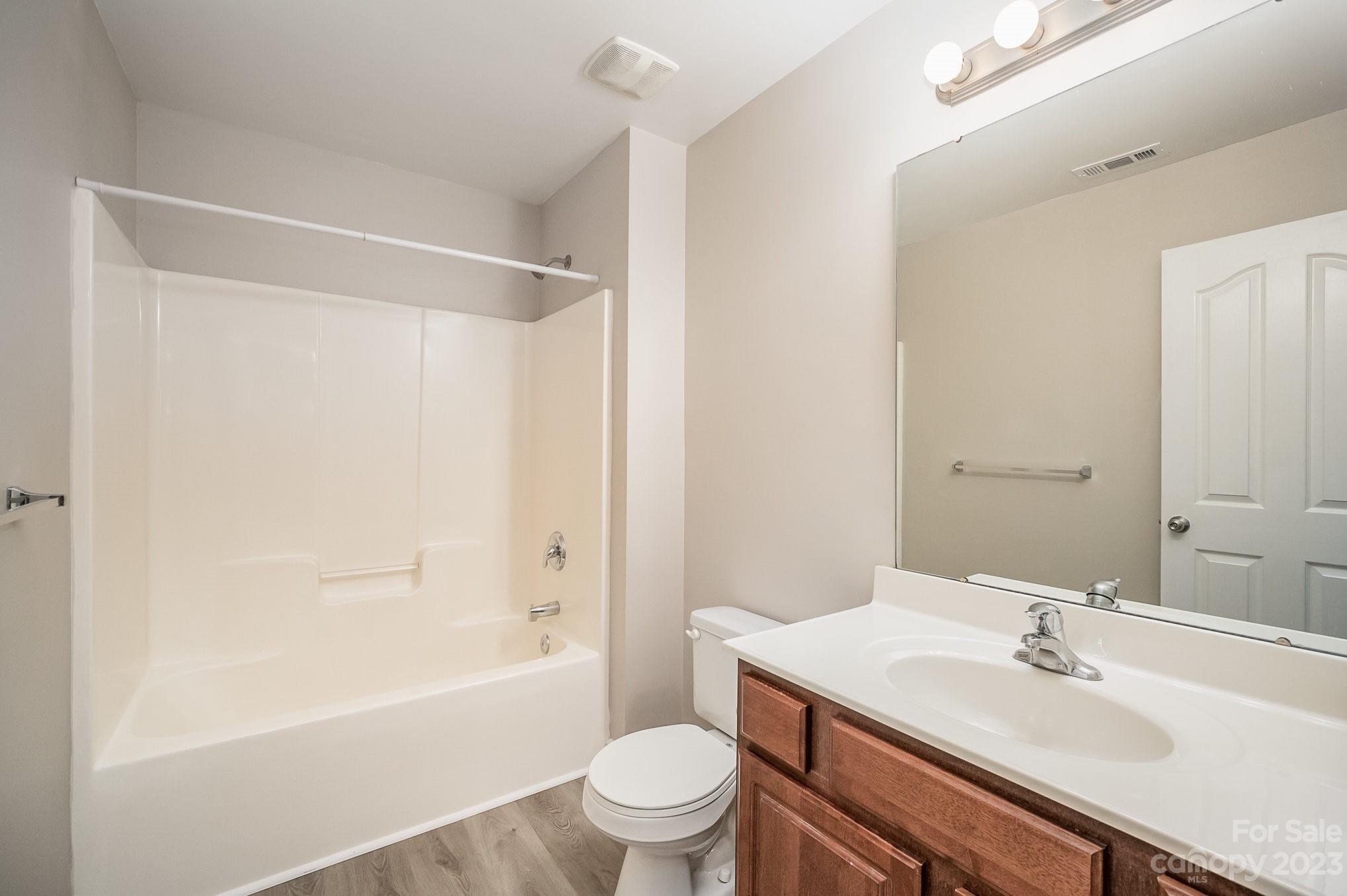 1400 Key Ridge Court Charlotte, NC 28216 - Photo 15 of 27 a bathroom with a sink a toilet and a large mirror