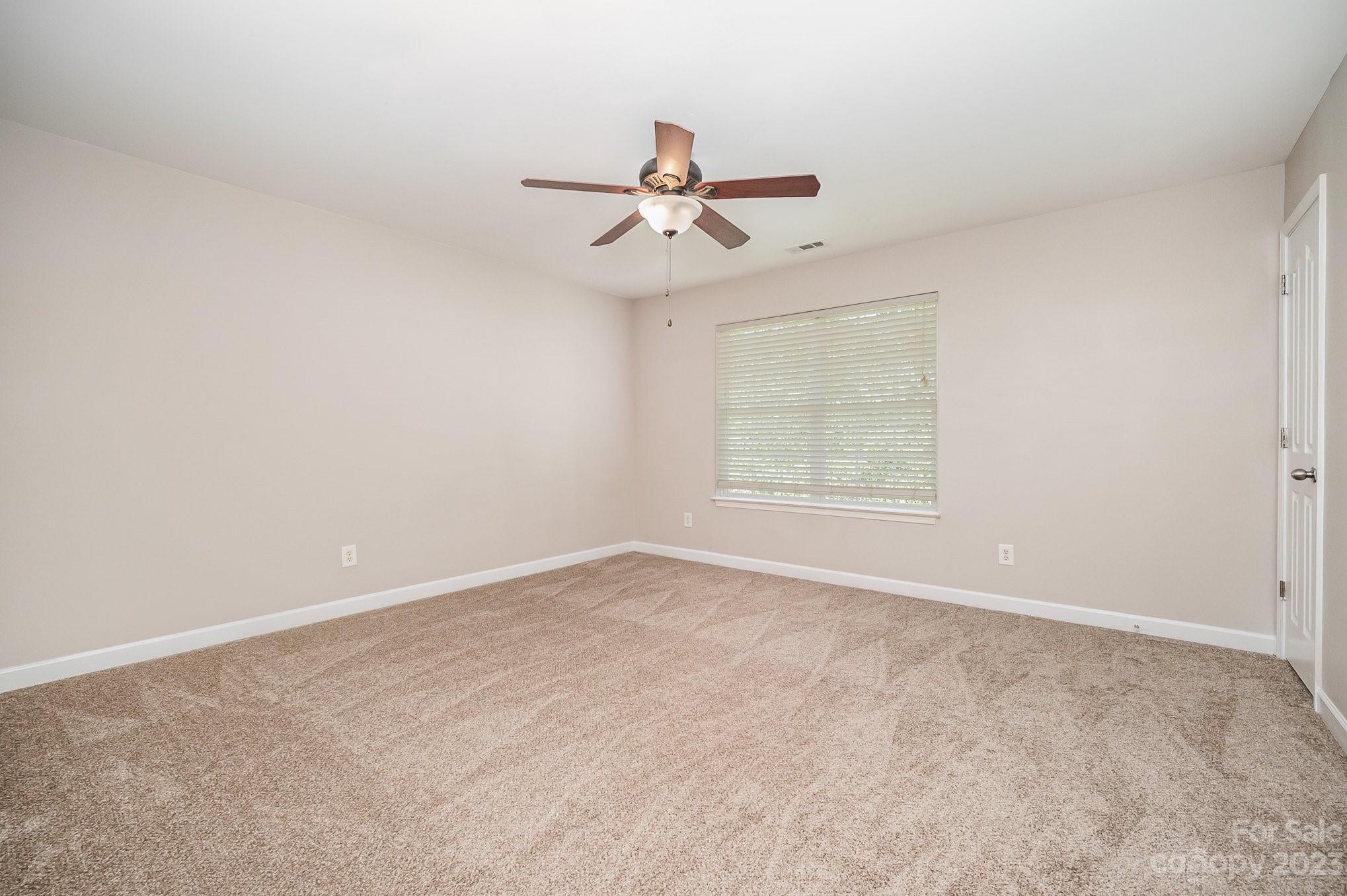 1400 Key Ridge Court Charlotte, NC 28216 - Photo 18 of 27 an empty room with windows and fan