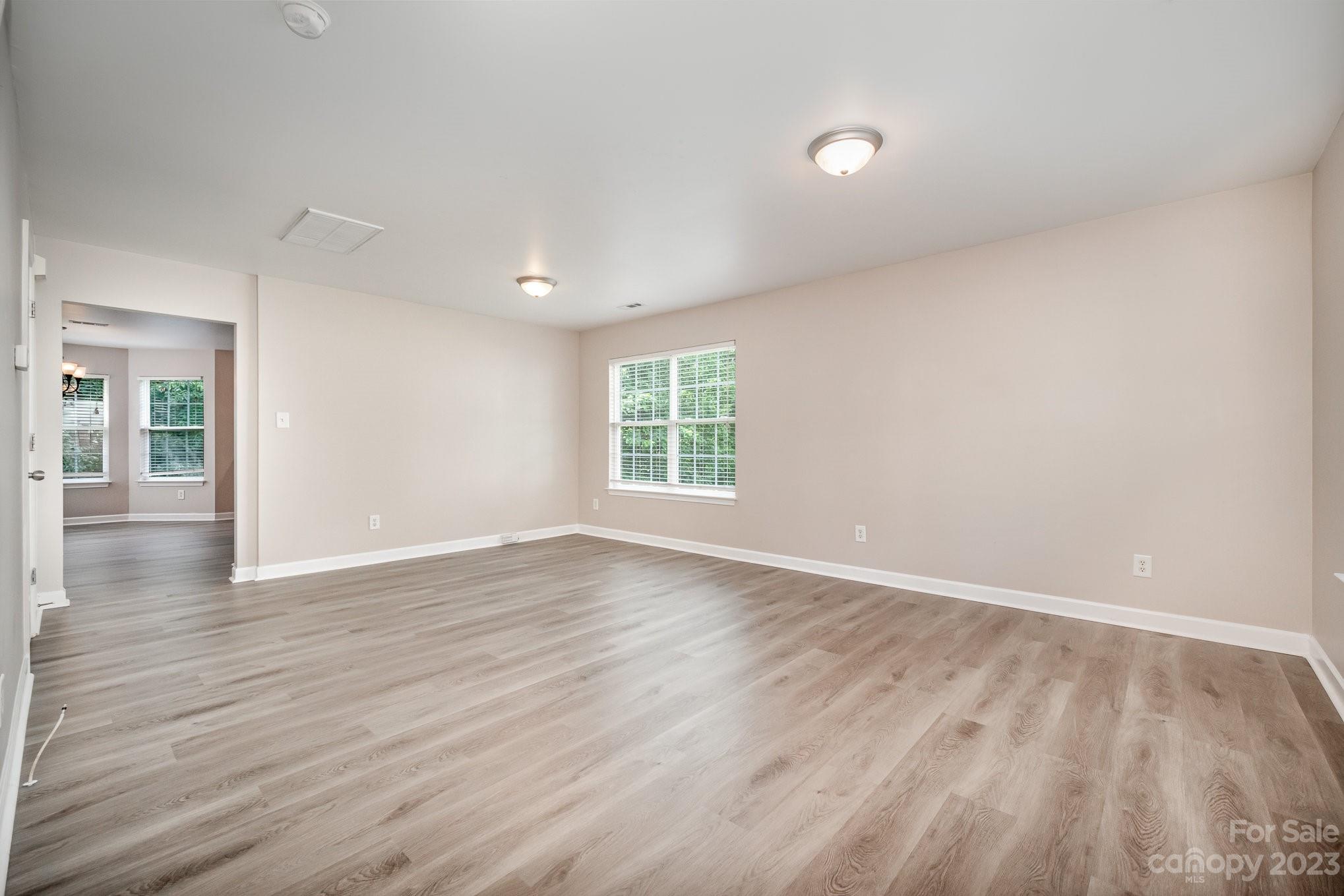 1400 Key Ridge Court Charlotte, NC 28216 - Photo 2 of 27 wooden floor in an empty room with a window