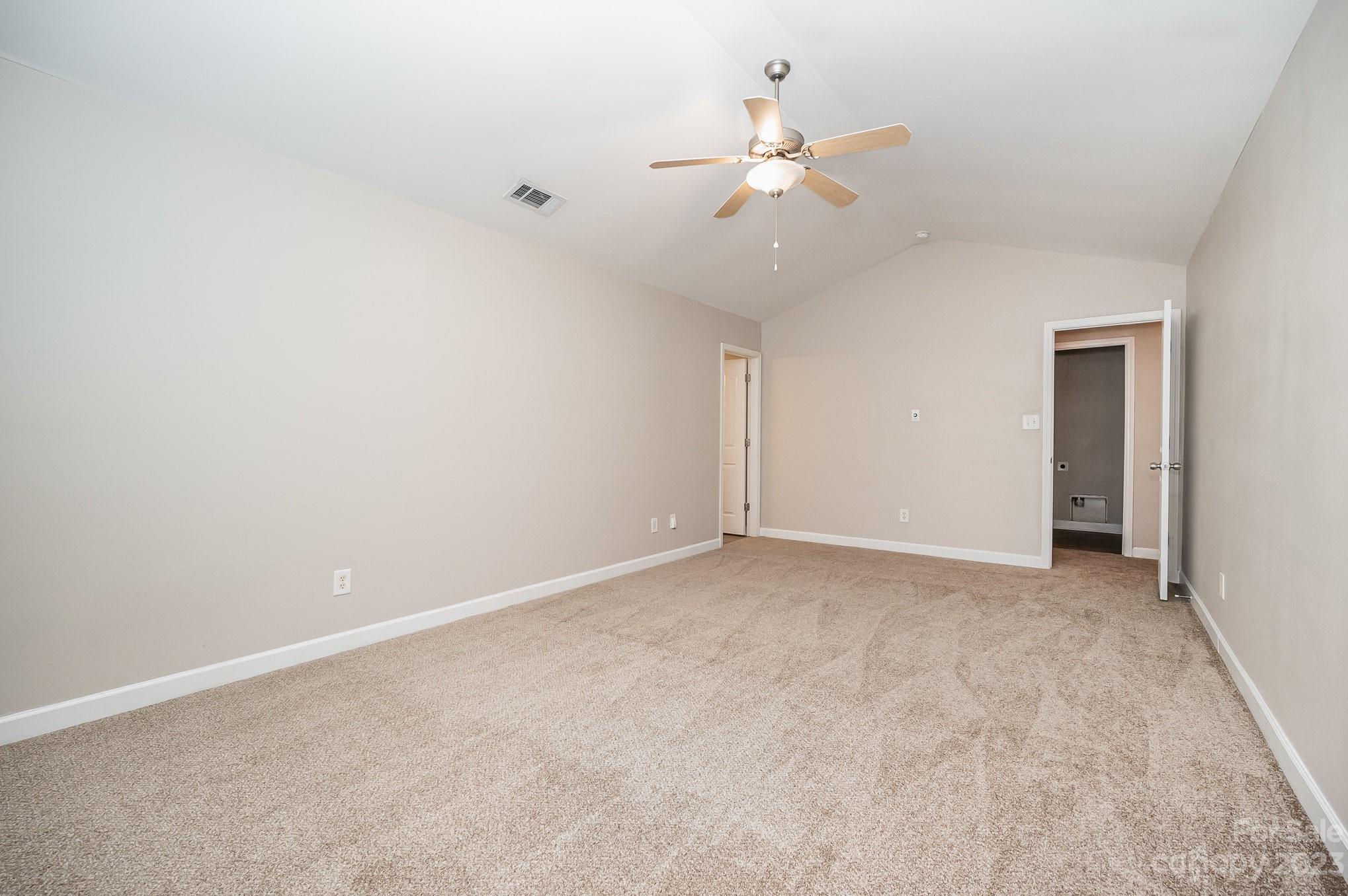 1400 Key Ridge Court Charlotte, NC 28216 - Photo 22 of 27 a view of an empty room with a chandelier fan