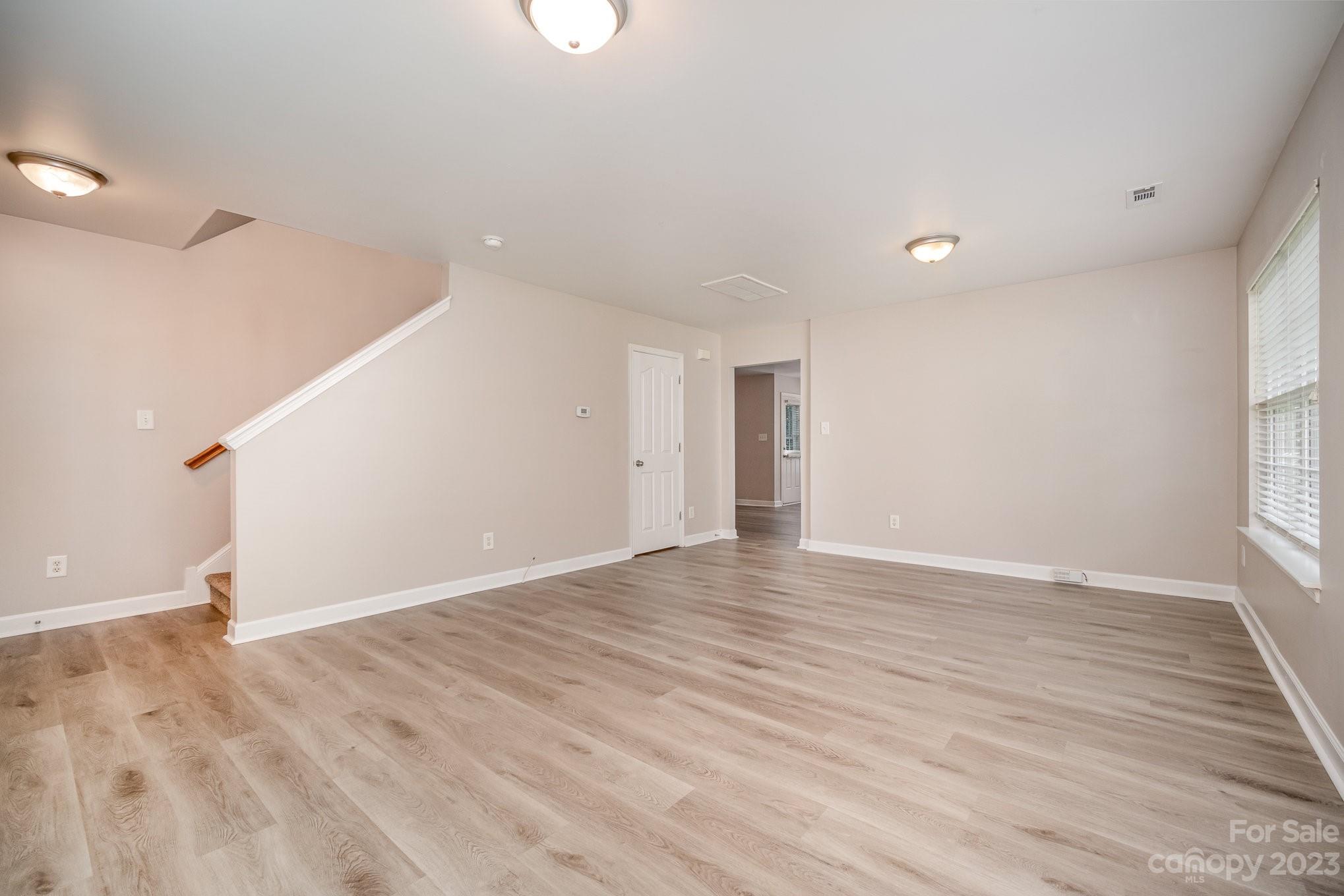 1400 Key Ridge Court Charlotte, NC 28216 - Photo 3 of 27 wooden floor in an empty room with a window