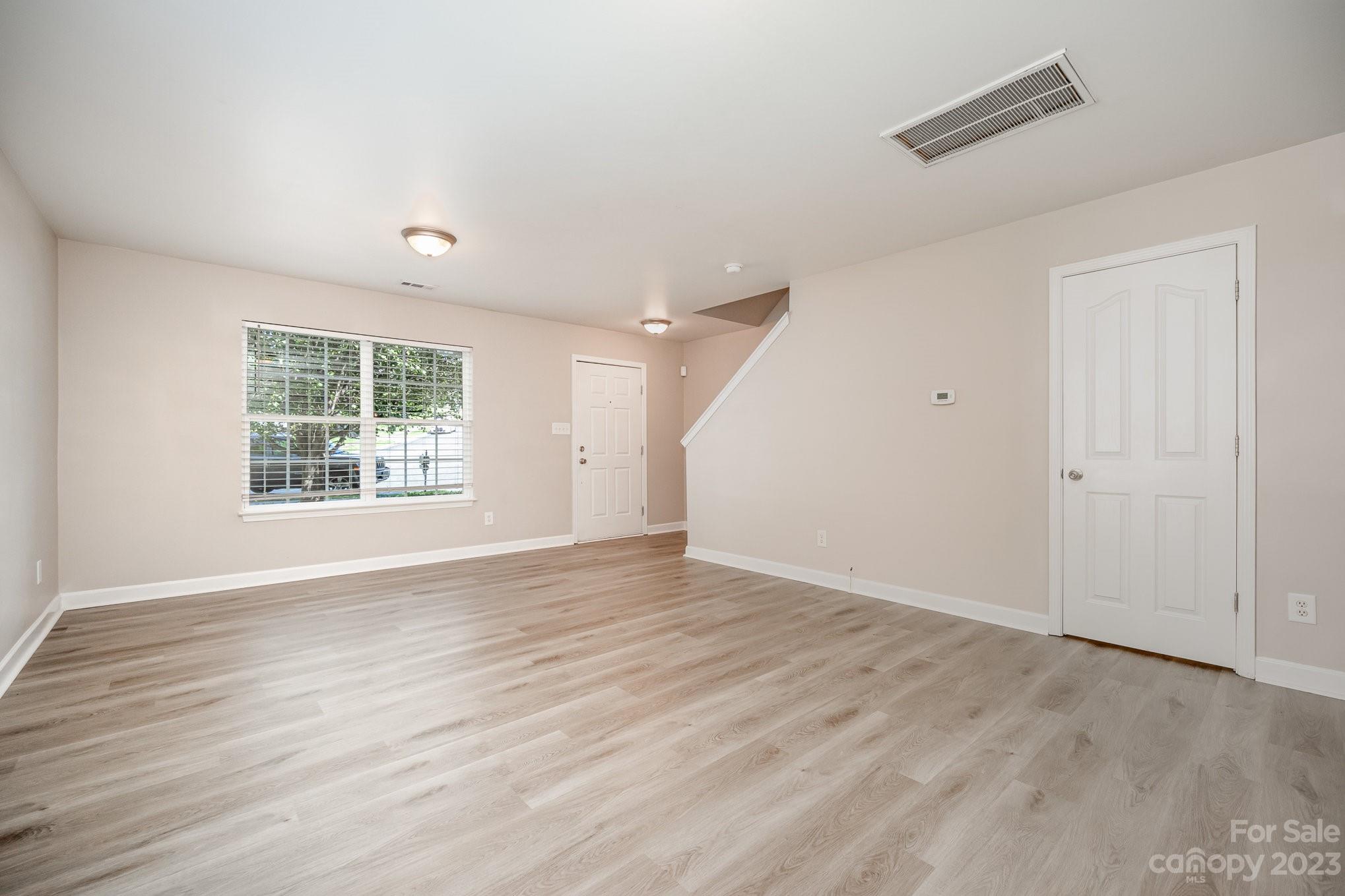1400 Key Ridge Court Charlotte, NC 28216 - Photo 4 of 27 an empty room with wooden floor and windows